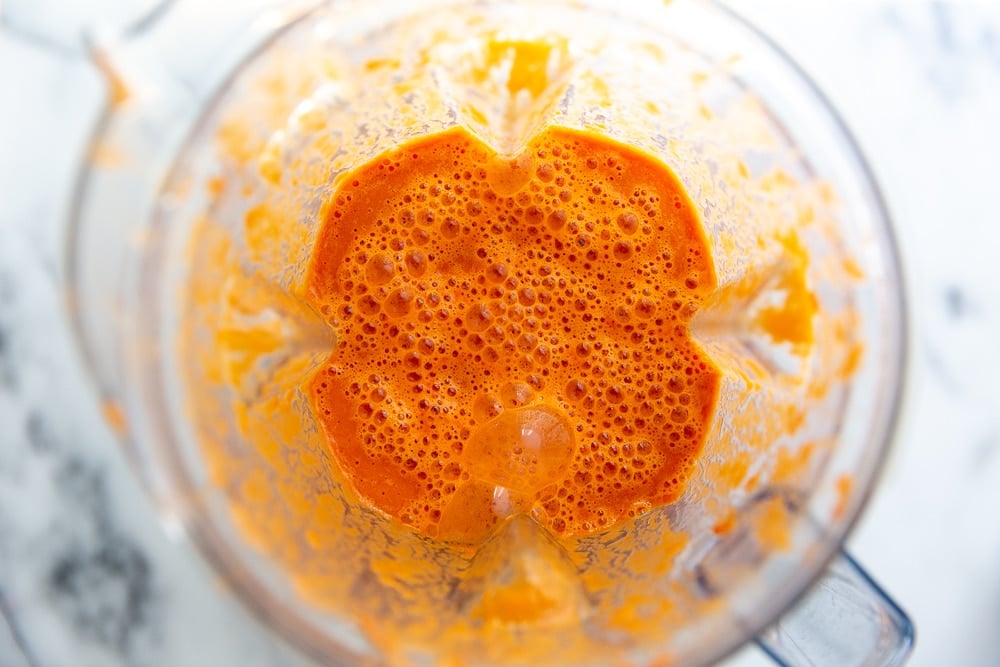 Process shot showing the creamy tomato soup in the Vitamix blender.