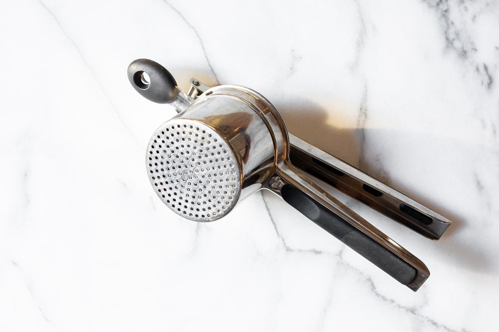 Potato ricer on a countertop.