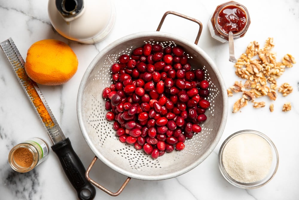 The ingredients for the easy cranberry sauce recipe arranged on a counter.