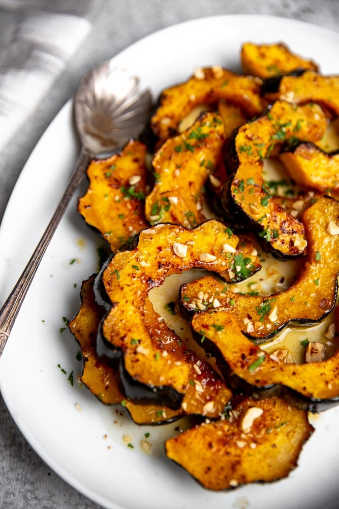 Roasted acorn squash rings on a serving platter.