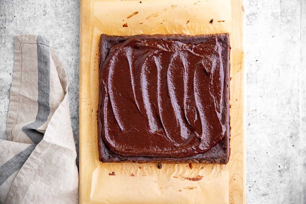 Overhead shot of black bean brownies topped with easy cacao frosting.