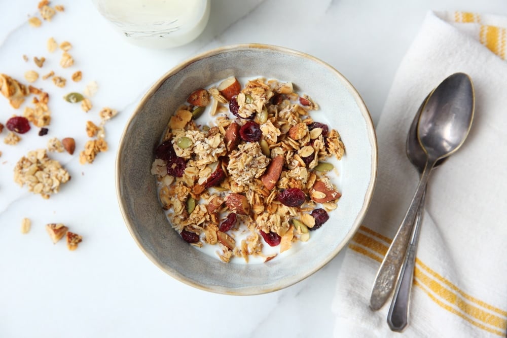 Gluten free granola in a bowl with spoons alongside. 