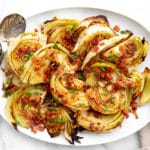 Platter of roasted cabbage wedges drizzled with a warm bacon vinaigrette.