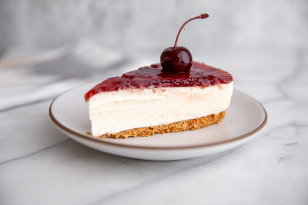 Close-up of a slice of mascarpone cheesecake on a plate. 