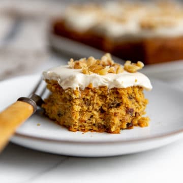Slice of gluten free carrot cake on a plate with a fork.