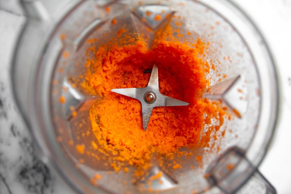 Finely chopped carrots in a Vitamix blender.