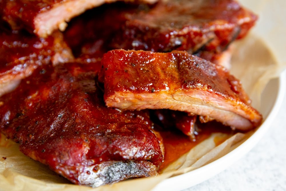 Close up of a smoked BBQ rib on a serving platter. 