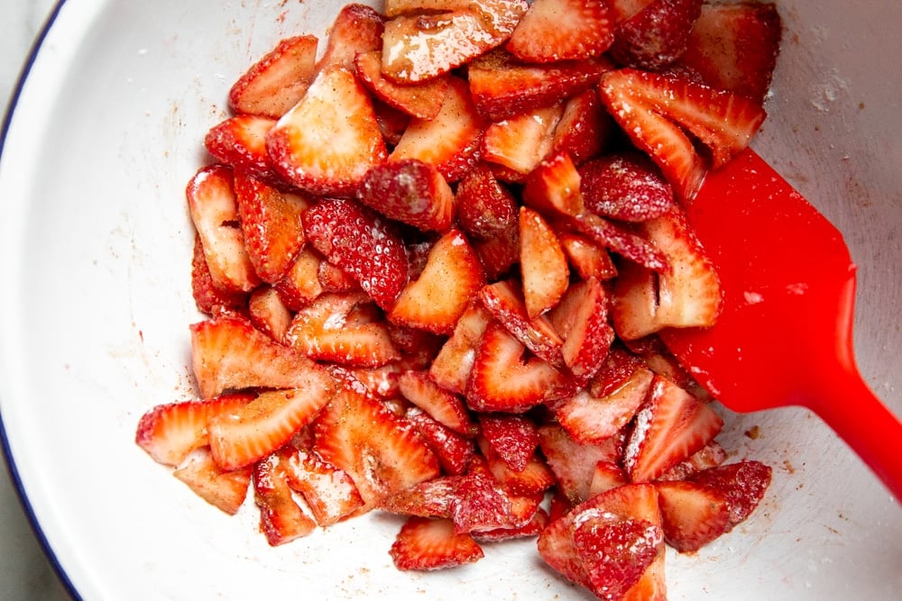The strawberry galette filling in a bowl with a spatula. 