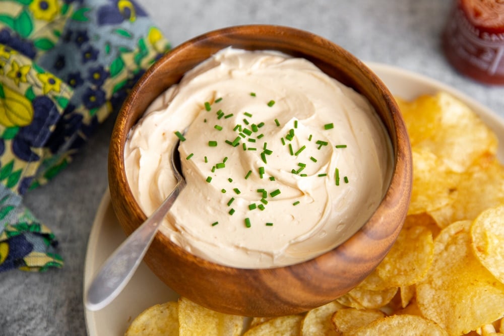 Creamy sriracha dip in a bowl with a spoon. 
