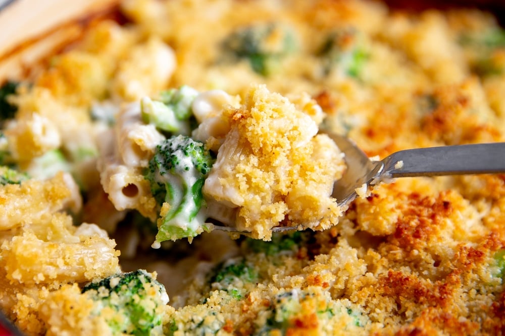 Close up of a spoonful of the creamy pasta bake. 