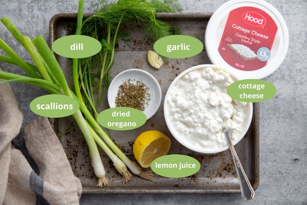 All of the ingredients for the healthy cottage cheese dip arranged on a pan. 