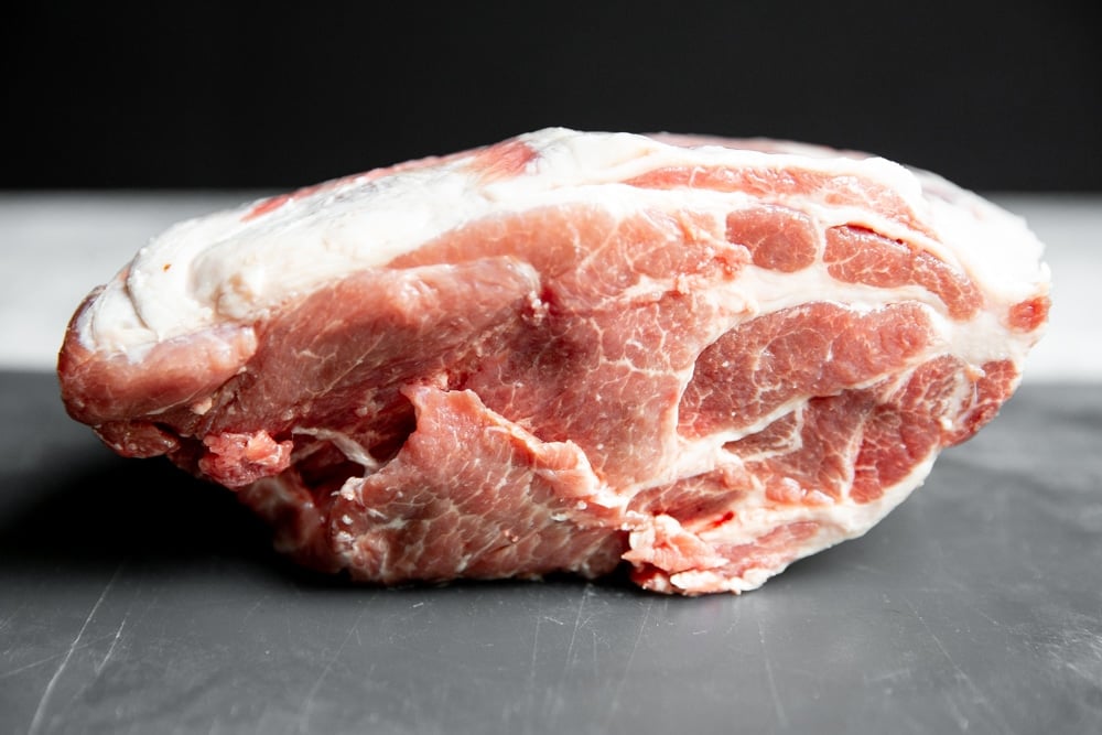 Pork shoulder on a cutting board. 