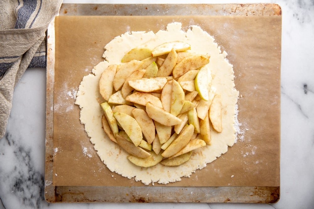 Apple filling piled onto a pie crust for the apple galette recipe. 