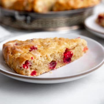 Cranberry orange scone on a serving plate.