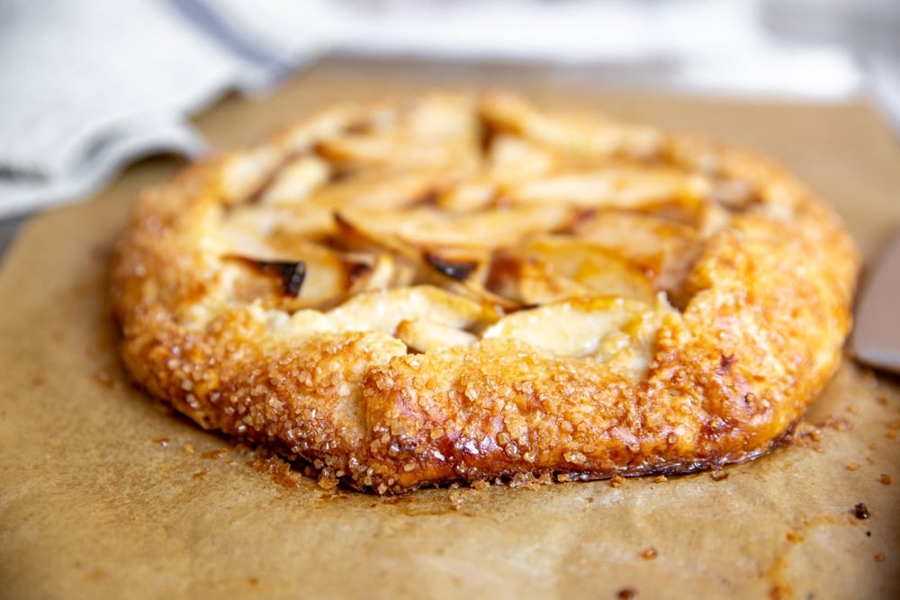 Gluten free apple galette on a piece of parchment paper.