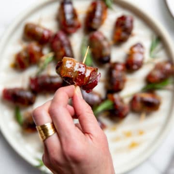 Close up of a hand holding a devils on horseback.
