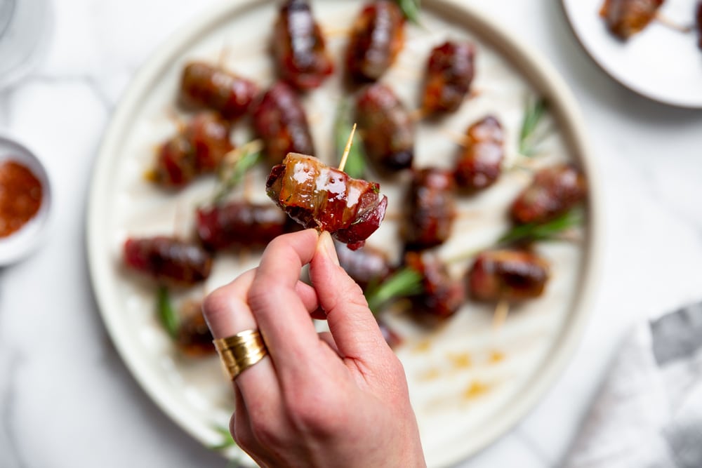 Close up of a hand holding a devils on horseback.