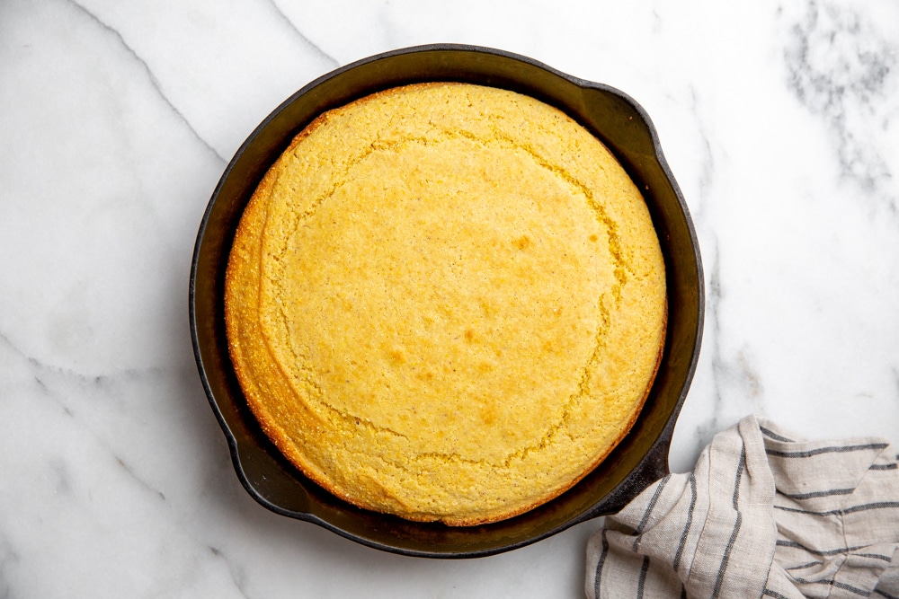 Baked cornbread in a cast iron skillet.