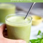 Hand holding a low sugar green smoothie.