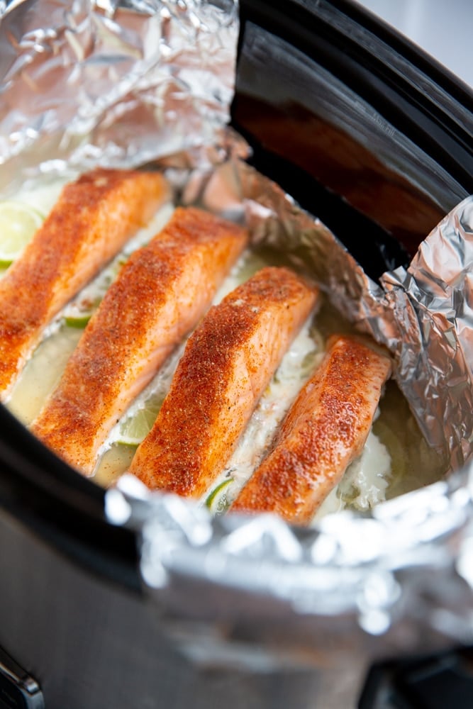 Poached salmon fillets in a slow cooker. 
