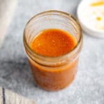 A jar of stir fry sauce on a work surface.