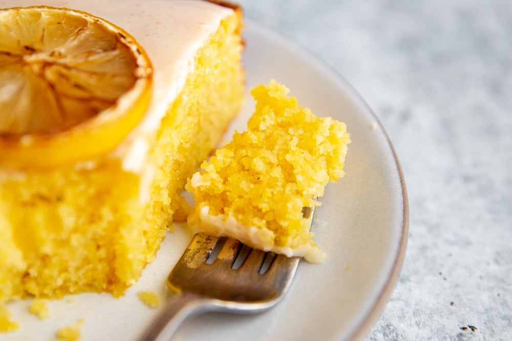 Close up of a forkful of lemon olive oil cake.