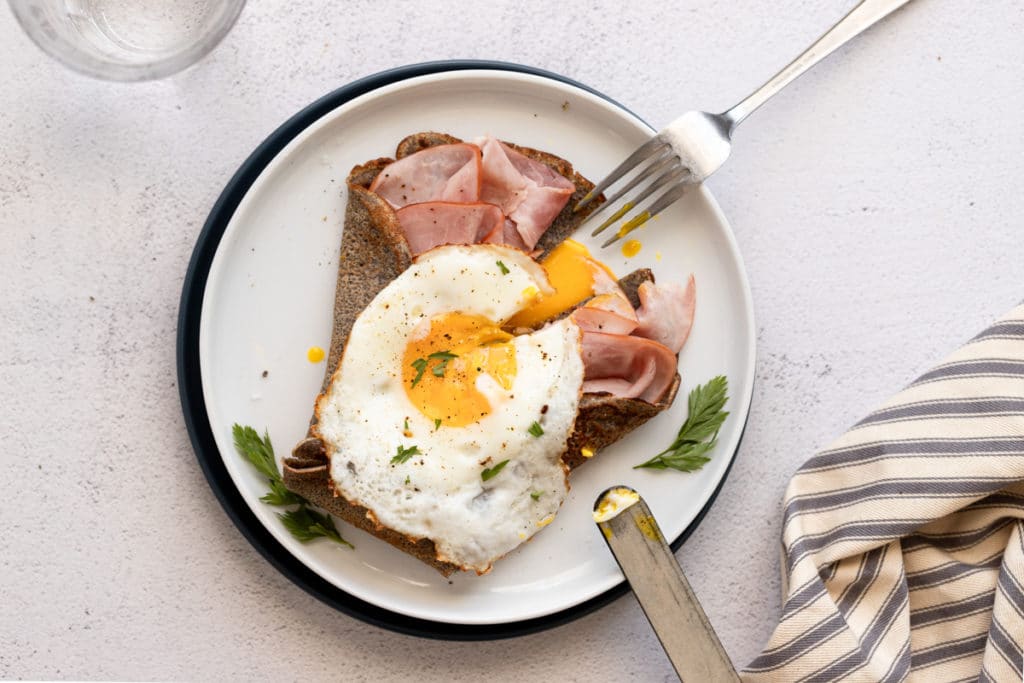 Buckwheat crepe filled with ham and topped with a fried egg.