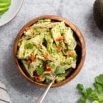 Avocado chicken salad in a bowl with a spoon.
