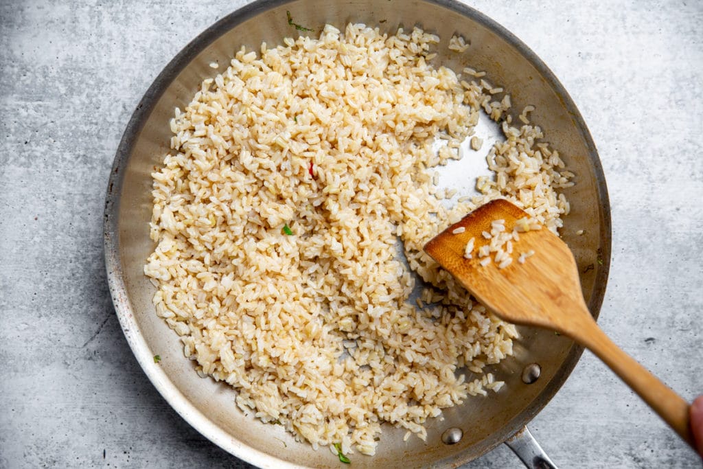 Brown rice cooking in a large skillet for the fried rice. 