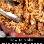 Traeger pulled pork in a pot with tongs.
