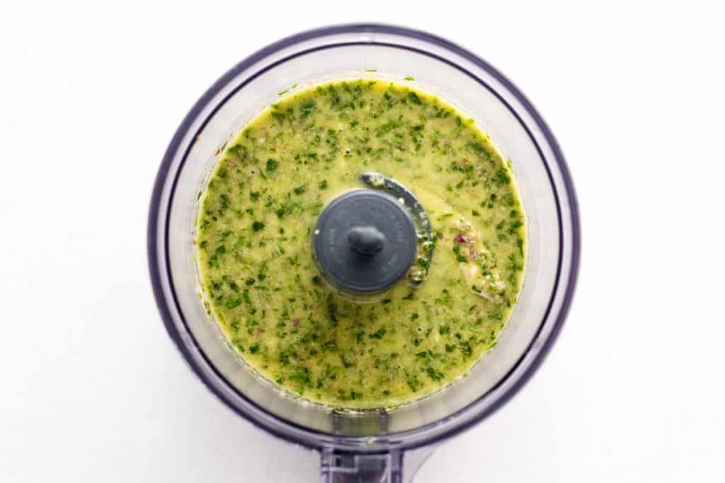 The blended salsa verde in a food processor.