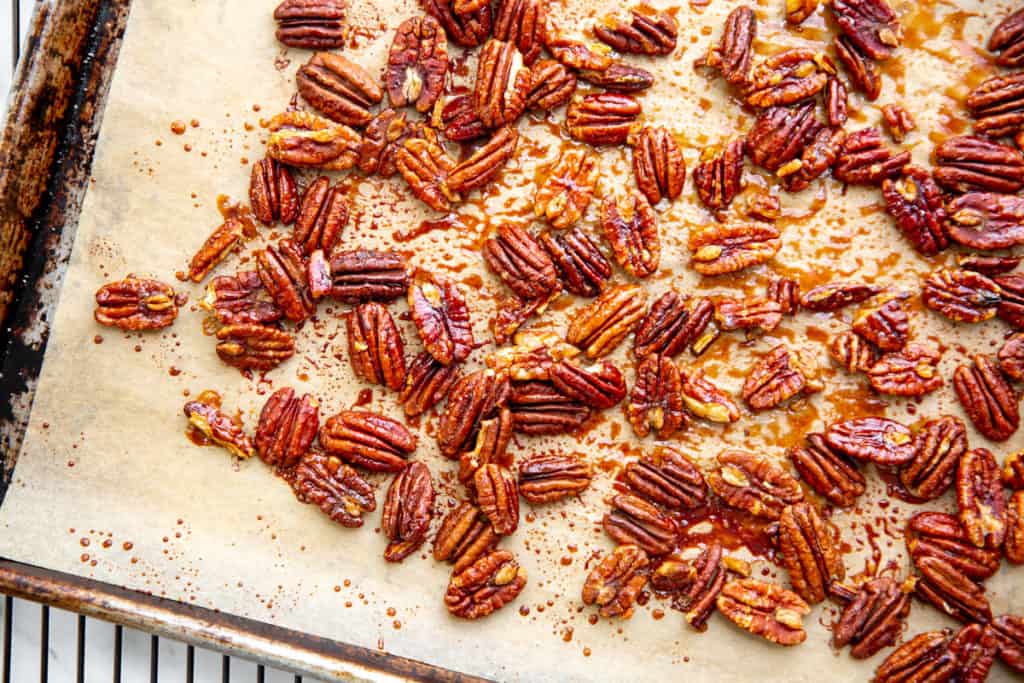 The cooked maple pecans on a baking sheet. 