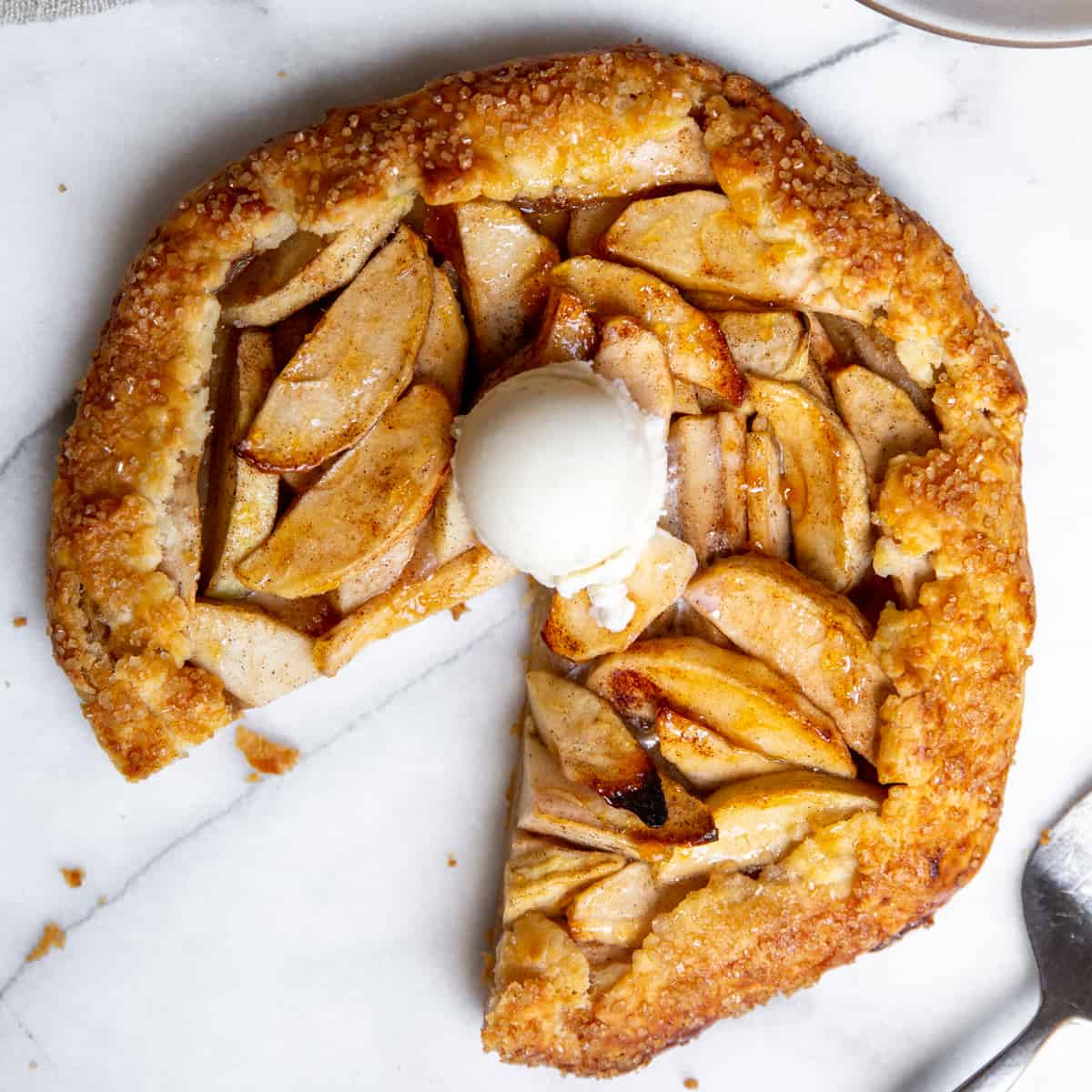 Holiday apple galette with one serving removed.