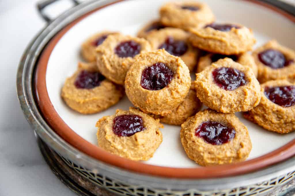 Raspberry vegan thumbprint cookies on a serving platter.