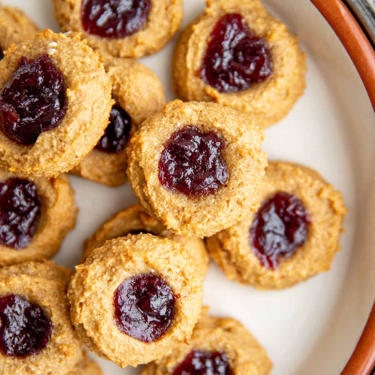 Gluten free vegan thumbprint cookies on a marble surface.