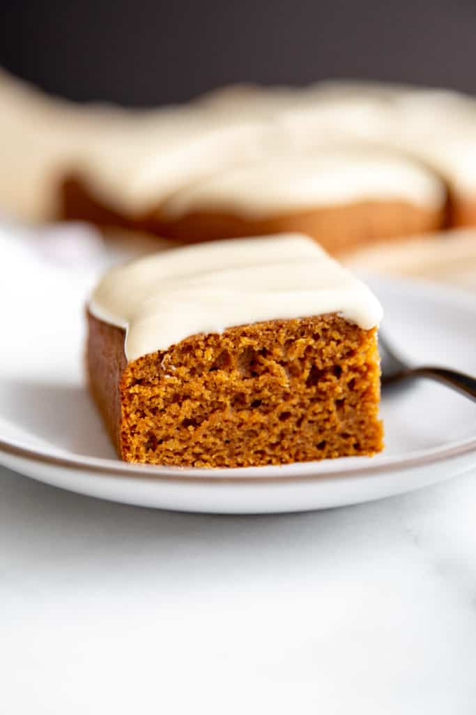 A slice of gluten free ginger cake on a plate. 