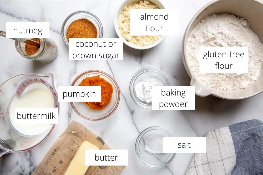 All of the ingredients for the gluten free biscuits recipe arranged on a marble surface with labels.