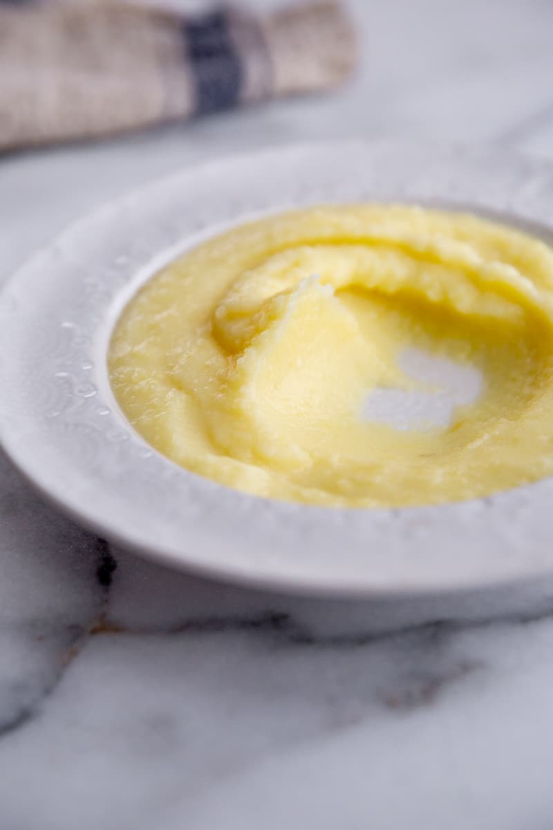 A swirl of pomme puree in a serving bowl.