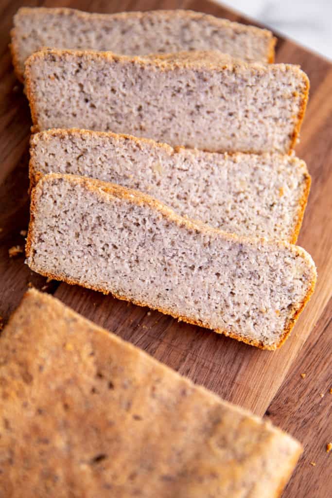 The grain free almond bread sliced on a wooden cutting board.