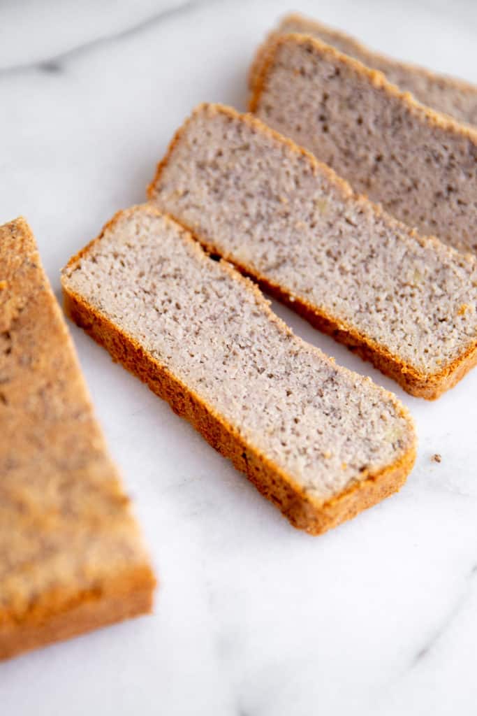 Slices of vegan almond bread on a marble surface.