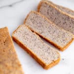 Vegan almond flour bread slices on a marble surface.