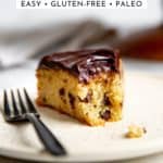 A slice of gluten free banana cake on a plate with a bite taken out.