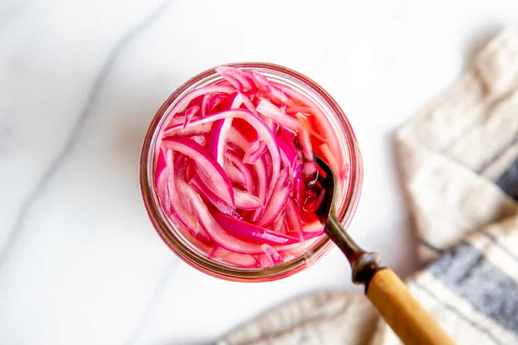 Overhead shot of a jar of pickled onions. 