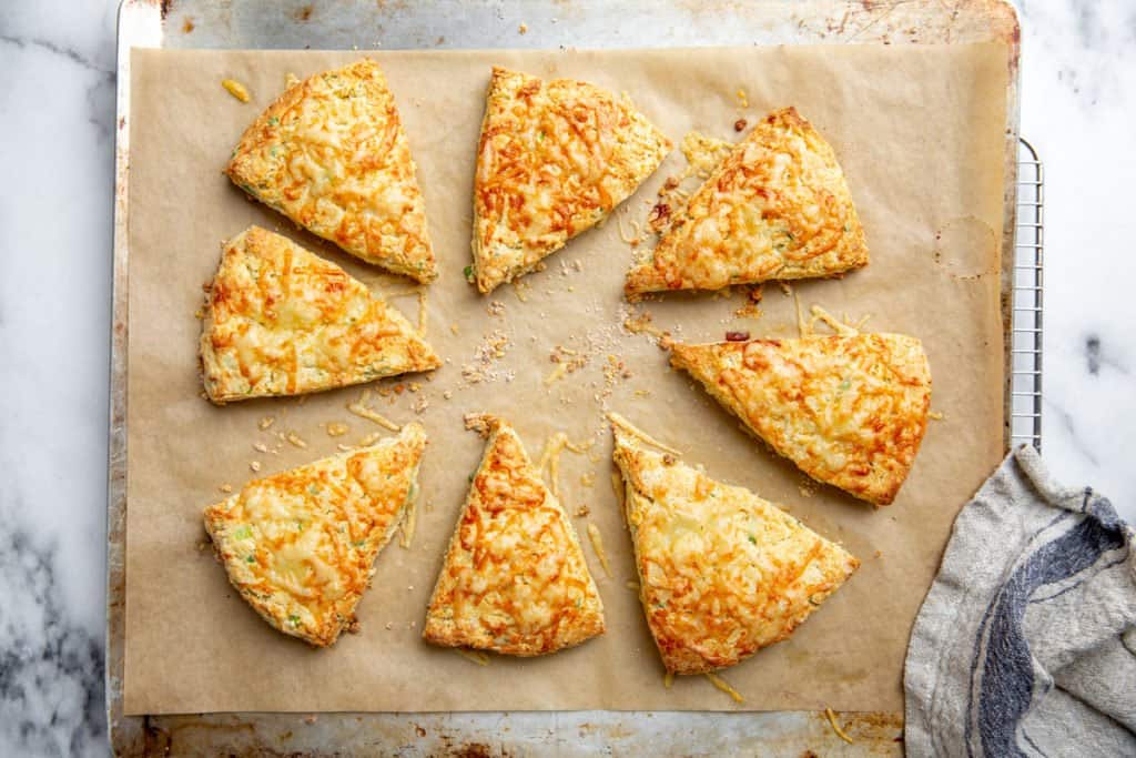 The baked cheese scones on a baking sheet. 
