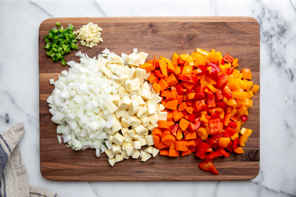 All of the chopped vegetables for the quinoa chili on a cutting board. 
