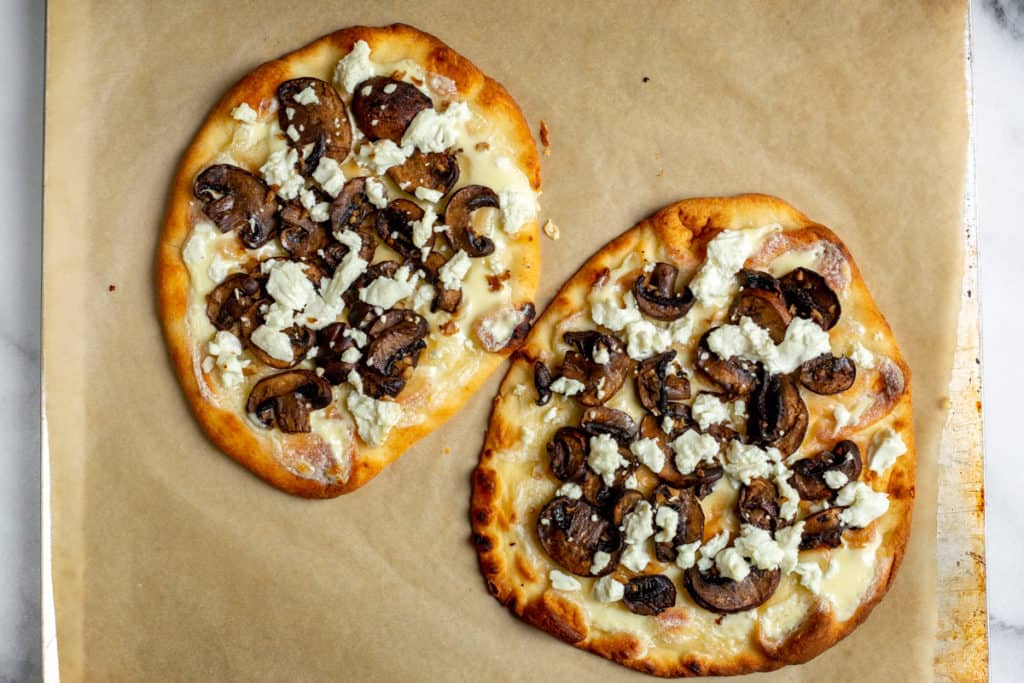 Flatbread pizzas topped with roasted mushrooms and goat cheese. 