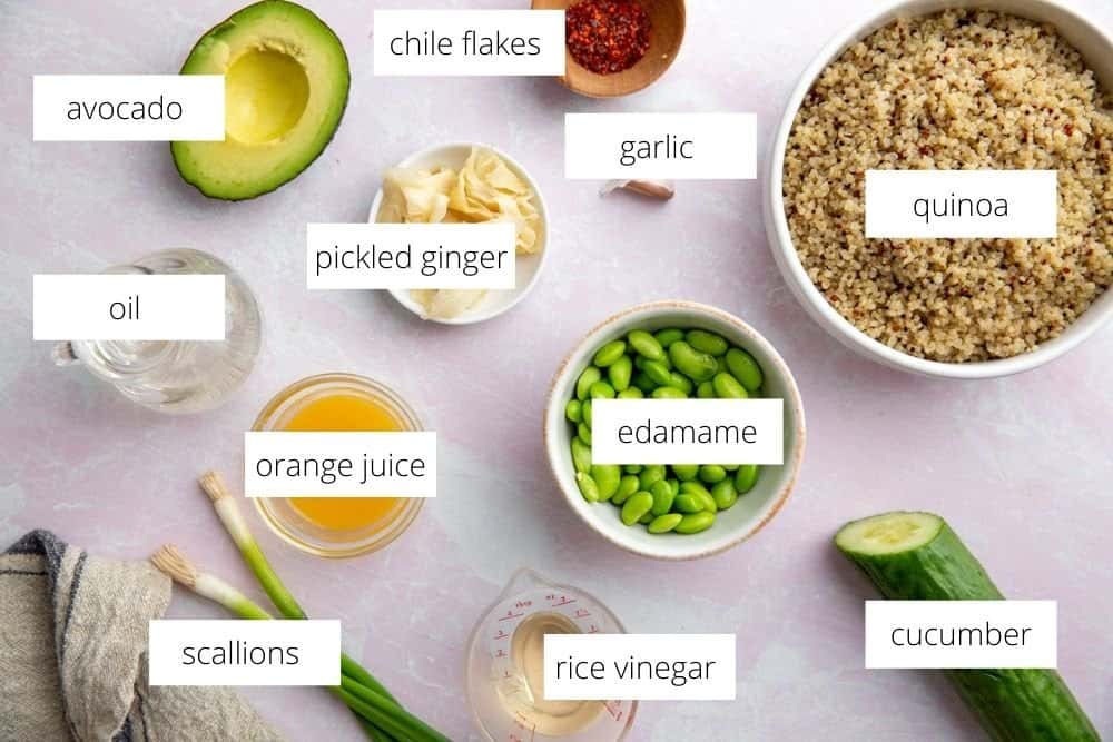 All of the ingredients for the edamame salad recipe on a surface with labels.