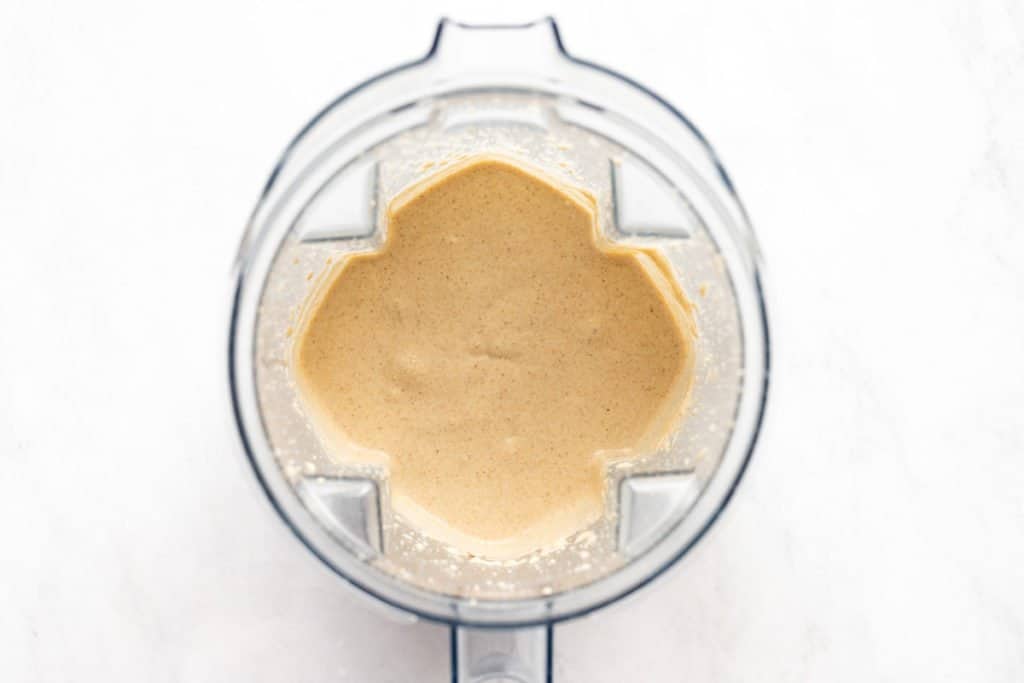 Process shot showing the blended banana oat pancake batter in a blender after adding the eggs. 