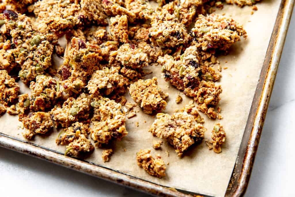 Granola clusters on a baking sheet. 