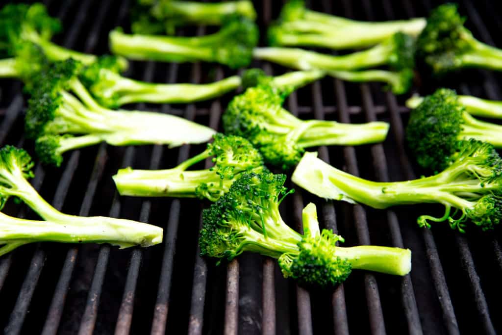 Broccoli spears arranged on a grill. 
